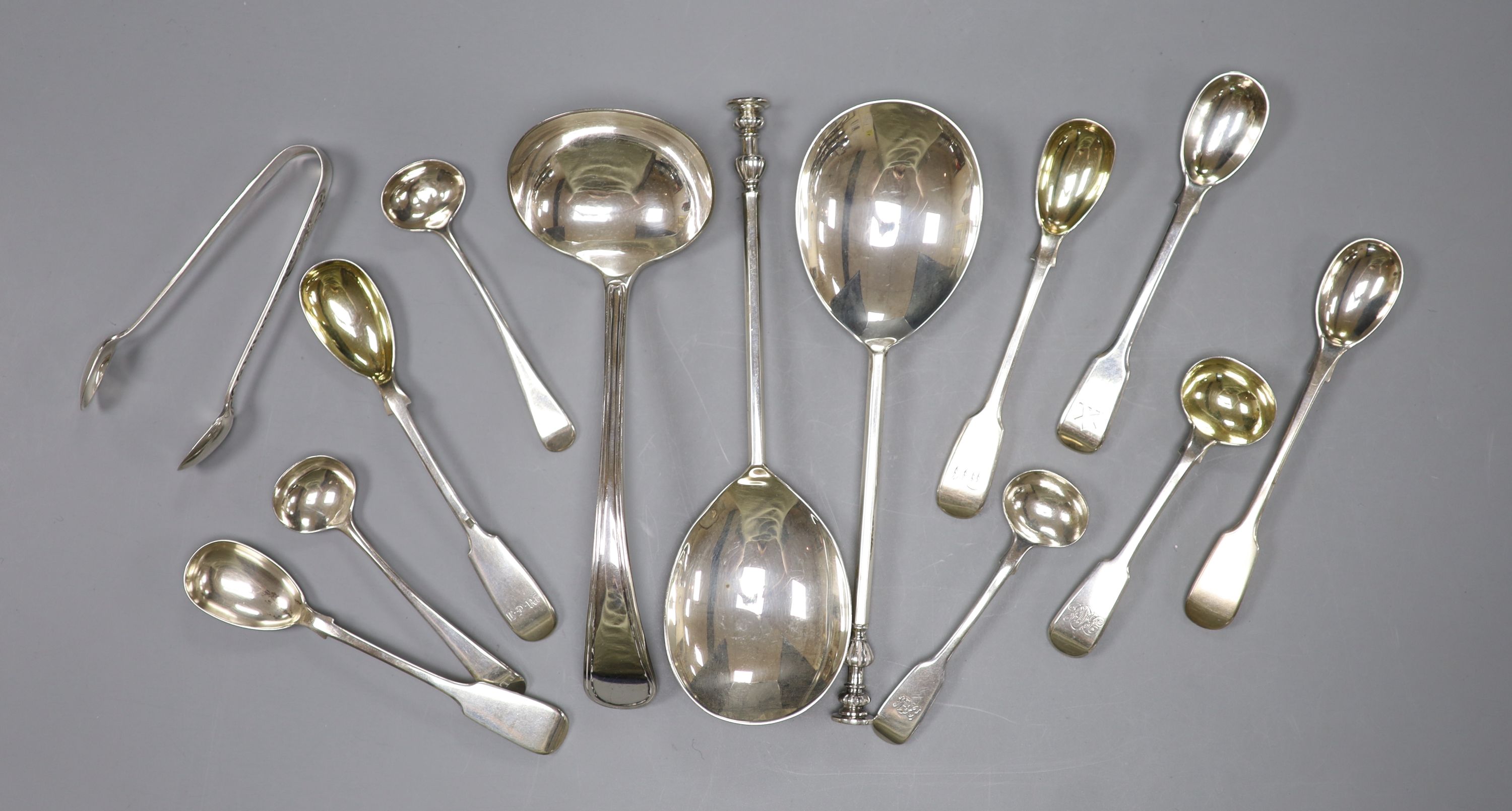 A pair of Mappin & Webb silver seal top spoons, five silver mustard spoons, four salts spoons, a pair of sugar tongs (Georgian and later) and a plated sauce ladle